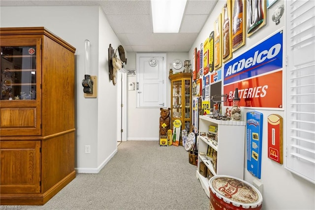 misc room featuring light colored carpet and a paneled ceiling