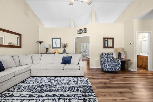 living room featuring ceiling fan, hardwood / wood-style flooring, and high vaulted ceiling