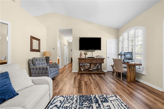 living room featuring lofted ceiling and hardwood / wood-style floors