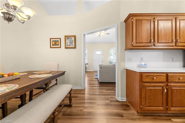 kitchen with light wood-type flooring and a chandelier