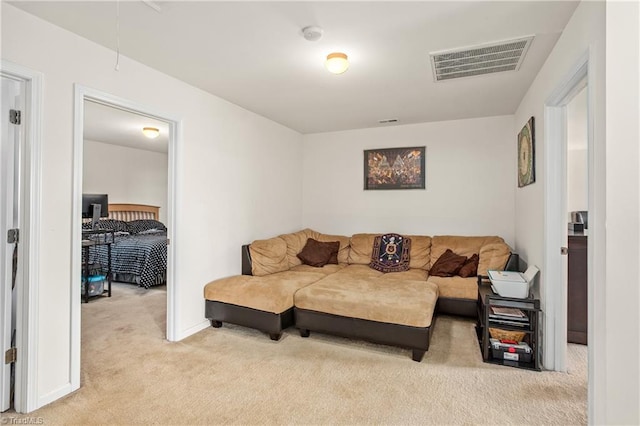 living area with baseboards, visible vents, attic access, and carpet flooring