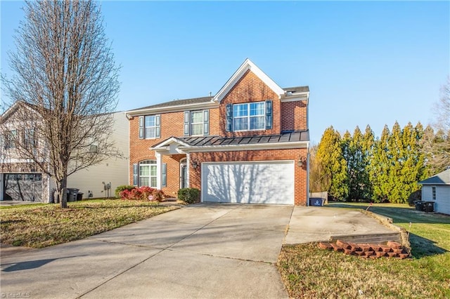 traditional home with brick siding, a standing seam roof, a garage, a front yard, and concrete driveway