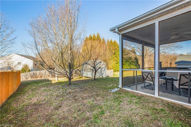 view of yard featuring a patio, a ceiling fan, a sunroom, and a fenced backyard