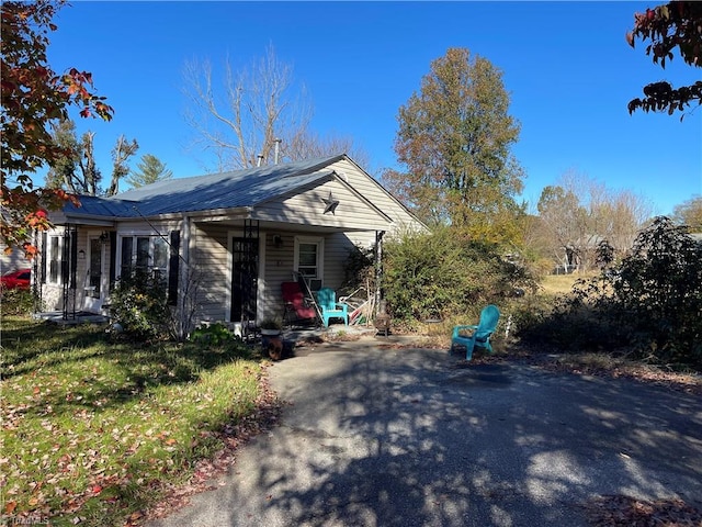 view of side of home with a lawn