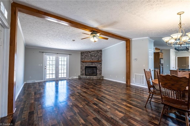 unfurnished living room with a fireplace, dark wood-style floors, and visible vents