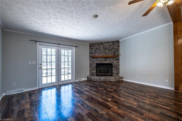 unfurnished living room with visible vents, a fireplace, crown molding, and wood finished floors