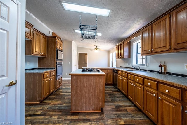 kitchen with a sink, dark wood-style floors, a kitchen island, and stainless steel appliances