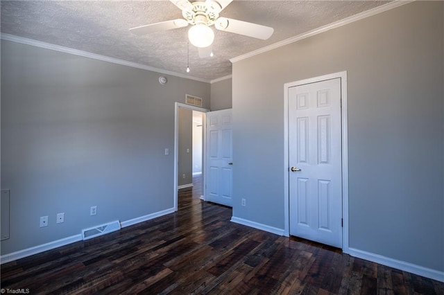 unfurnished bedroom featuring baseboards, dark wood-style floors, visible vents, and a textured ceiling