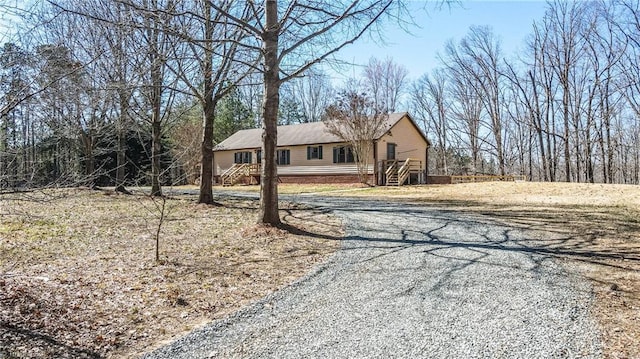 ranch-style home with gravel driveway