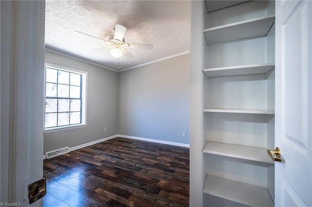 unfurnished room with visible vents, ornamental molding, wood finished floors, a textured ceiling, and a ceiling fan