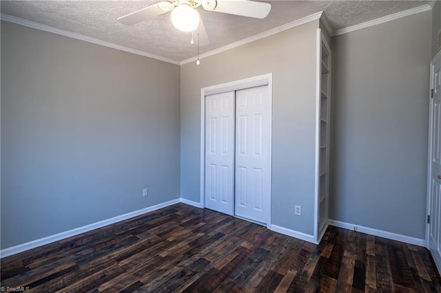 unfurnished bedroom featuring dark wood-style floors, baseboards, ornamental molding, a closet, and a textured ceiling