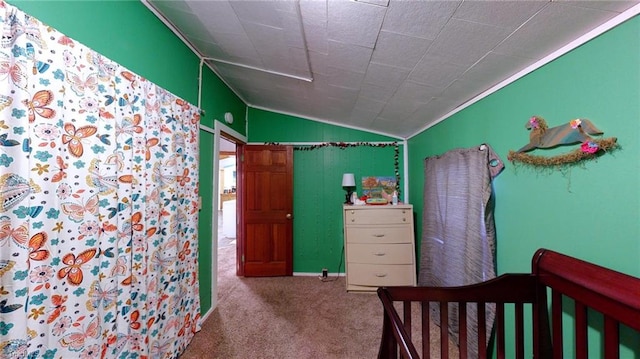 bedroom featuring lofted ceiling and light carpet