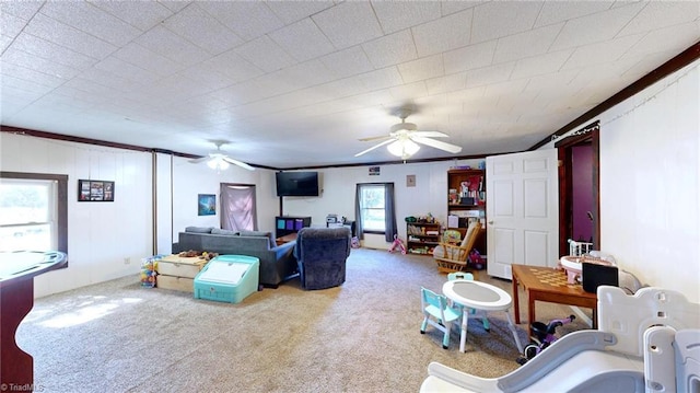 carpeted living room with ceiling fan