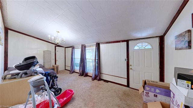 interior space featuring ornamental molding, a notable chandelier, and carpet