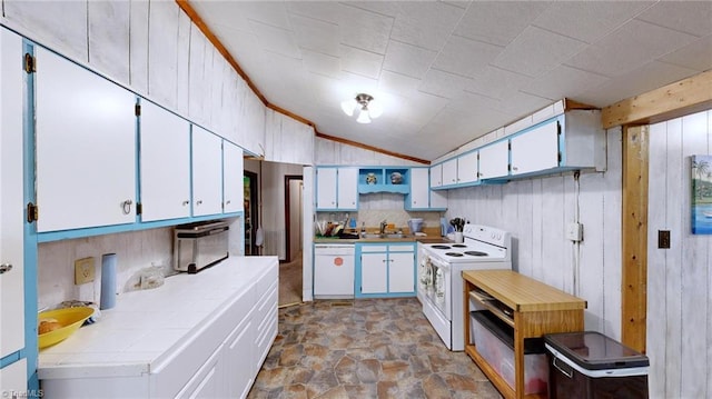 kitchen featuring lofted ceiling, white appliances, sink, white cabinetry, and tile counters