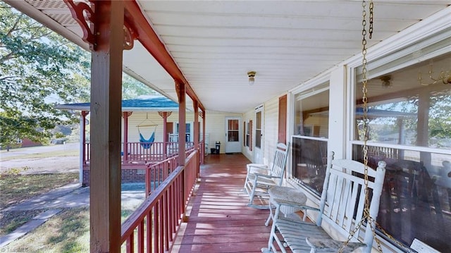 wooden terrace featuring covered porch