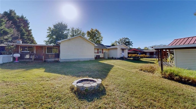 exterior space with a front lawn and an outdoor fire pit