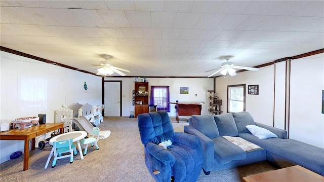 carpeted living room featuring ceiling fan and crown molding