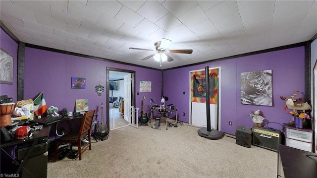 interior space with ornamental molding, light carpet, and ceiling fan