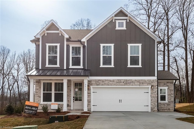 view of front facade with stone siding, driveway, an attached garage, and board and batten siding