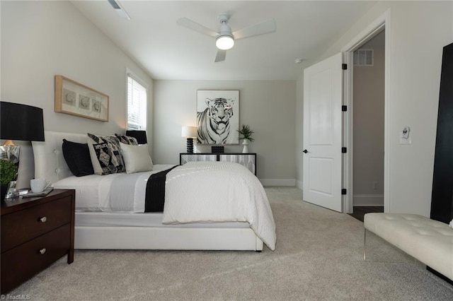 carpeted bedroom featuring visible vents, baseboards, and ceiling fan