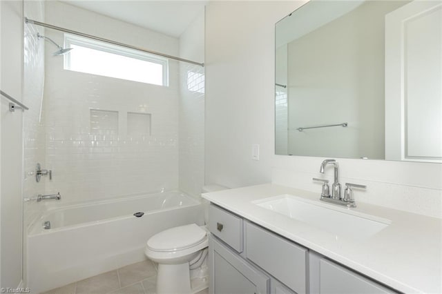 bathroom featuring tile patterned flooring, tub / shower combination, toilet, and vanity