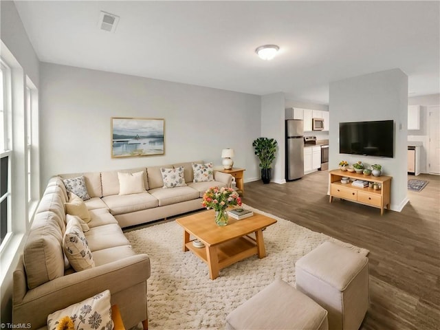 living room featuring dark wood-type flooring