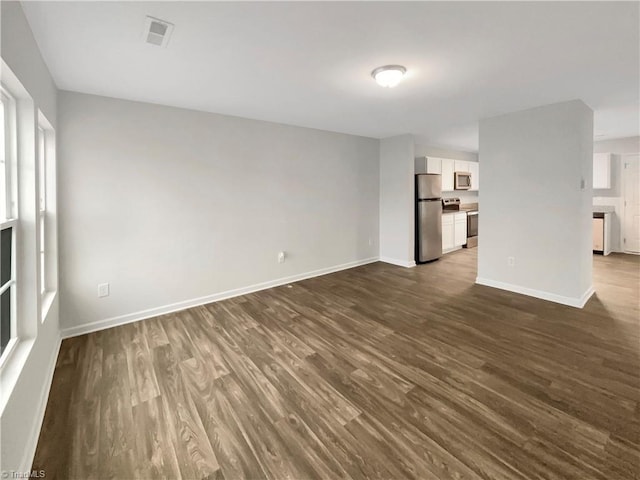 unfurnished living room with dark wood-type flooring