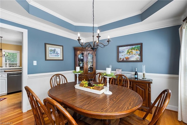 137 Bradford Place Ln, Lewisville, NC 27023 - dining space with a chandelier, wainscoting, light wood finished floors, crown molding, and a raised ceiling