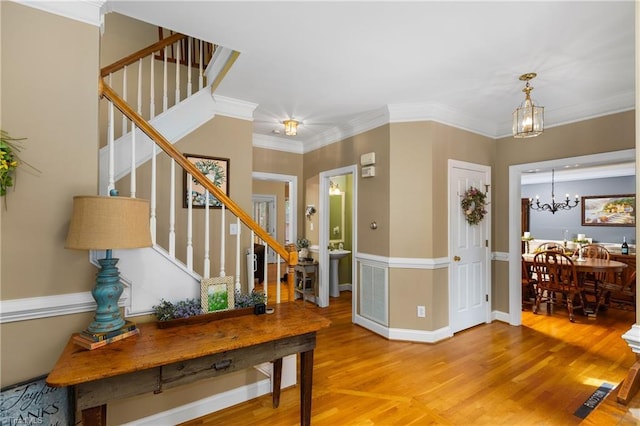 137 Bradford Place Ln, Lewisville, NC 27023 - foyer entrance featuring stairway, wood finished floors, a chandelier, and crown molding