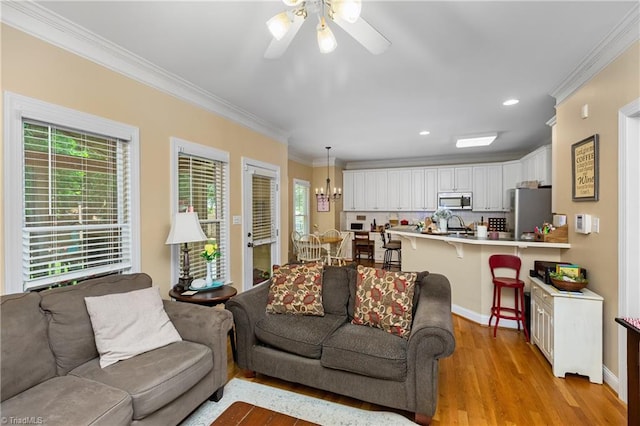 137 Bradford Place Ln, Lewisville, NC 27023 - living area with ornamental molding, plenty of natural light, ceiling fan, light wood finished floors, and recessed lighting