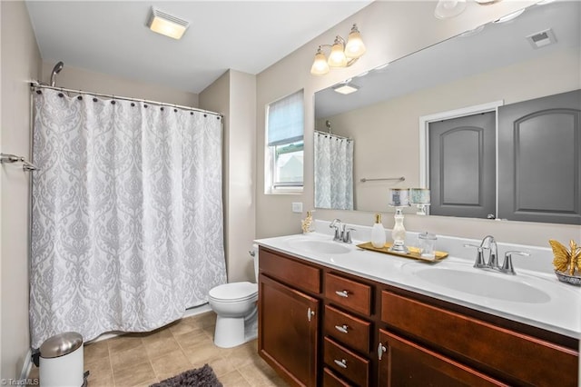 bathroom with tile patterned floors, vanity, and toilet