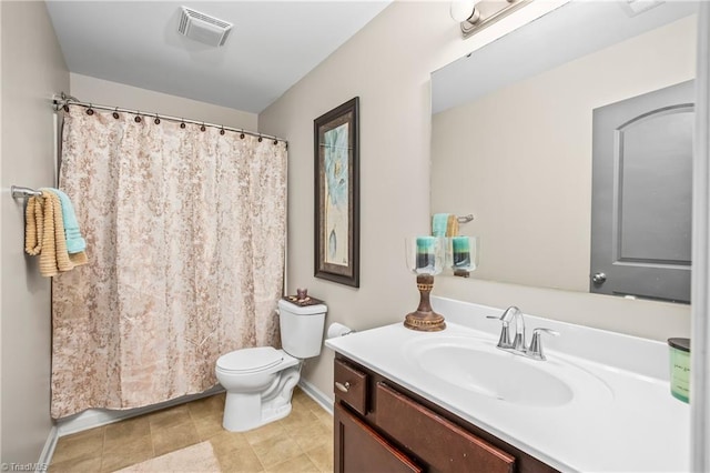 bathroom featuring tile patterned floors, vanity, and toilet