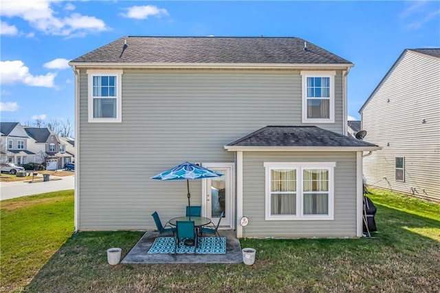 rear view of property with a lawn and a patio area