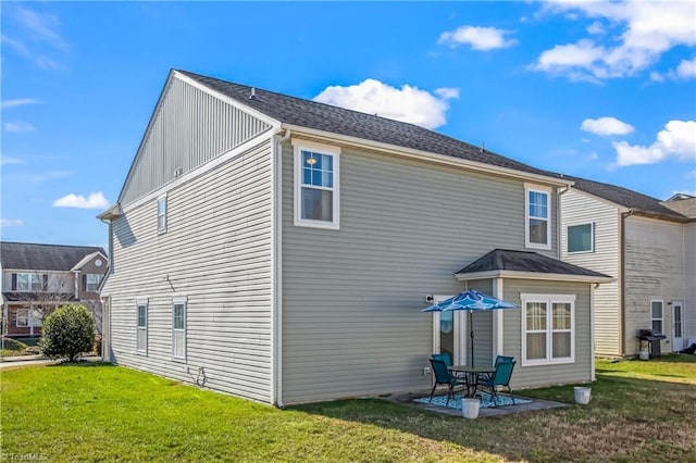 rear view of house with a yard and a patio area