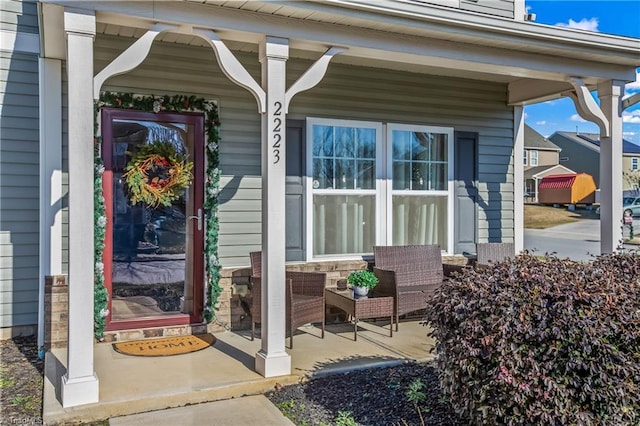 view of exterior entry featuring covered porch