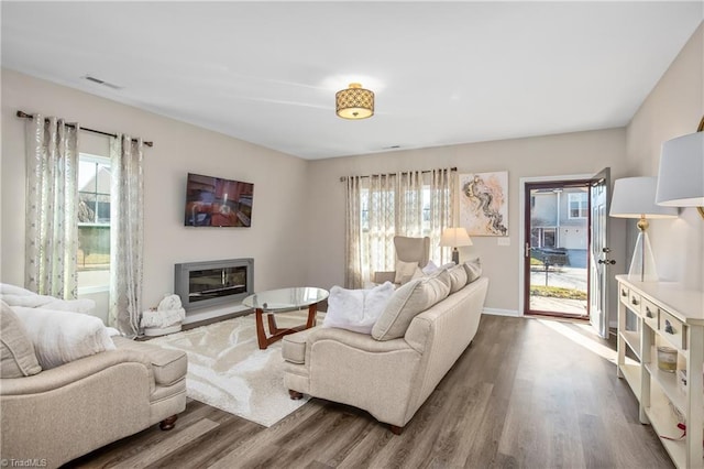 living room featuring dark hardwood / wood-style flooring and a wealth of natural light