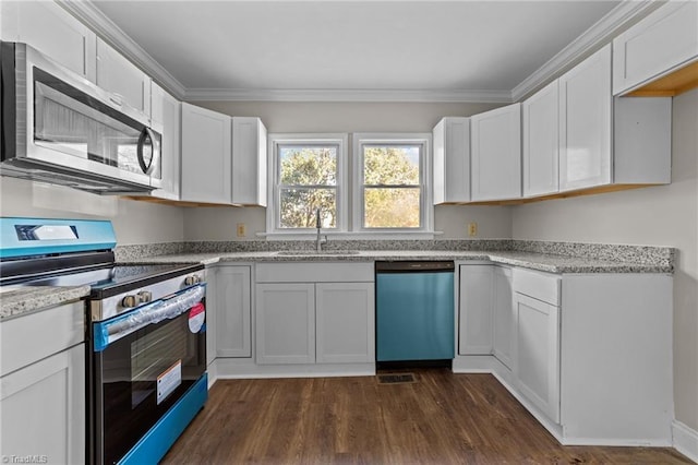 kitchen featuring dark hardwood / wood-style floors, crown molding, white cabinets, appliances with stainless steel finishes, and sink