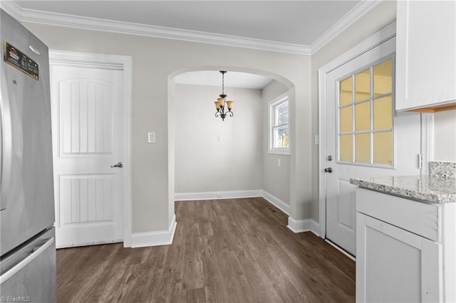 interior space featuring ornamental molding, dark wood-type flooring, and a chandelier