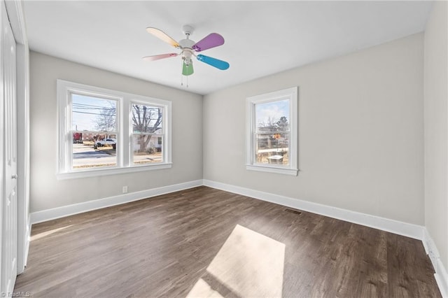 spare room featuring ceiling fan and dark hardwood / wood-style flooring