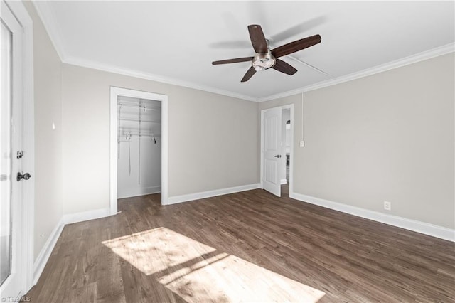 unfurnished bedroom with ceiling fan, dark hardwood / wood-style flooring, ornamental molding, and a closet