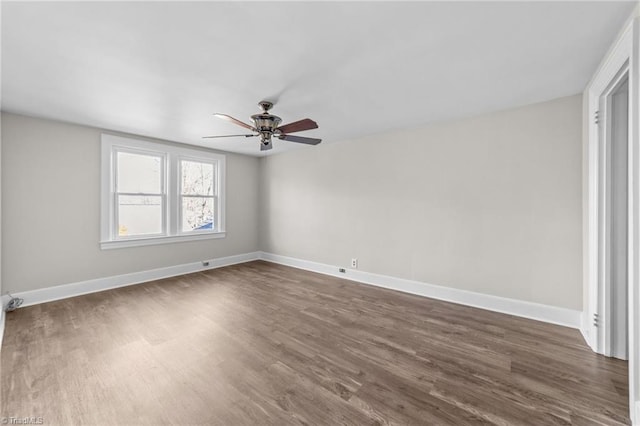 empty room featuring ceiling fan and dark hardwood / wood-style floors