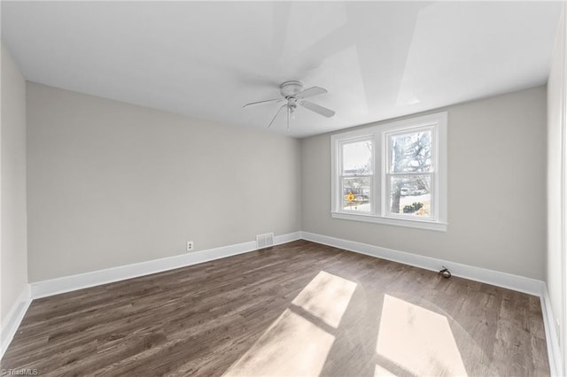 empty room featuring ceiling fan and dark hardwood / wood-style floors