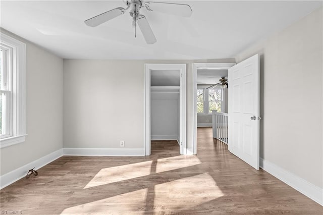 unfurnished bedroom featuring a closet, ceiling fan, and light hardwood / wood-style flooring