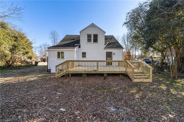 rear view of property featuring a wooden deck