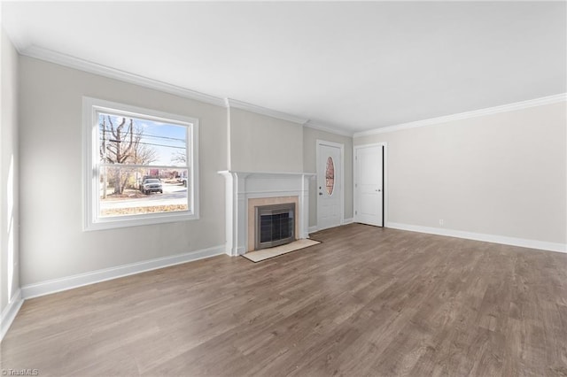 unfurnished living room featuring ornamental molding and hardwood / wood-style flooring