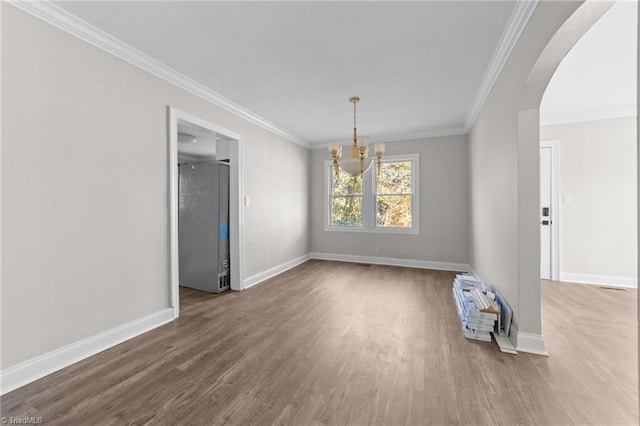 unfurnished dining area with ornamental molding, a notable chandelier, and hardwood / wood-style floors