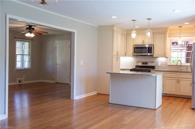 159 Evans Ln, Wilkesboro, NC 28697 - kitchen featuring a wealth of natural light, light stone countertops, light wood-style floors, decorative backsplash, and appliances with stainless steel finishes