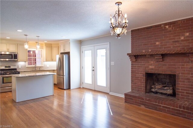 159 Evans Ln, Wilkesboro, NC 28697 - kitchen with a wealth of natural light, a textured ceiling, light wood-style floors, and stainless steel appliances