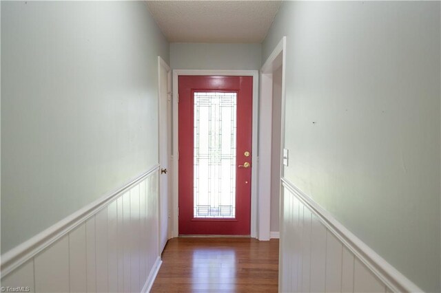 159 Evans Ln, Wilkesboro, NC 28697 - doorway featuring a decorative wall, a wainscoted wall, wood finished floors, and a textured ceiling